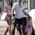 Supermodel Alessandra Ambrosio puts on a furry leopard hat as she walks with her husband Jamie Mazur and daughter Anja Louise