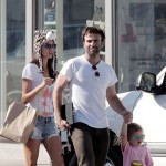 Supermodel Alessandra Ambrosio puts on a furry leopard hat as she walks with her husband Jamie Mazur and daughter Anja Louise