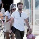 Supermodel Alessandra Ambrosio puts on a furry leopard hat as she walks with her husband Jamie Mazur and daughter Anja Louise
