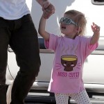 Supermodel Alessandra Ambrosio puts on a furry leopard hat as she walks with her husband Jamie Mazur and daughter Anja Louise
