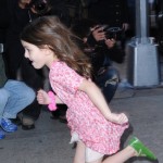 Suri Cruise runs past photographers on her way home as mom, Katie Holmes strides in at a more normal speed on November 7, 2011 in new York City, New York. Suri Cruise runs past photographers on her way home as mom, Katie Holmes strides in at a more normal speed on November 7, 2011 in new York City, New York.