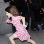 Suri Cruise runs past photographers on her way home as mom, Katie Holmes strides in at a more normal speed on November 7, 2011 in new York City, New York. Suri Cruise runs past photographers on her way home as mom, Katie Holmes strides in at a more normal speed on November 7, 2011 in new York City, New York.