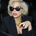 Monday December 12, 2011. Lady Gaga signs autographs for her fans as she leaves her New York City hotel. The pop superstar was seen wearing a pair of cat eye sunglasses as well as a black blazer with just a black bra underneath.