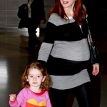 Alyson Hannigan shows off a huge baby bump as she arrives at JFK Airport in New York with husband Alexis Denisof and daughter Satyana. Alyson Hannigan shows off a huge baby bump as she arrives at JFK Airport in New York with husband Alexis Denisof and daughter Satyana.
