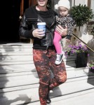 Pink is all smiles as she leaves her hotel carrying daughter Willow and a cup of coffee on September 13, 2012 in London, England.