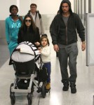 Kourtney Kardashian And Family Arriving On A Flight At LAX