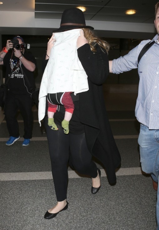 Shy Adele And Family Departing On A Flight At LAX