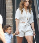 Jennifer Lopez carries her children Max and Emme around the set of her new music