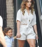 Jennifer Lopez carries her children Max and Emme around the set of her new music
