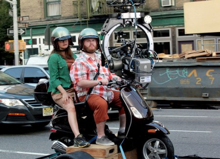 Alicia Silverstone films scenes on a Vespa with her co-stars from ‘Gods Behaving Badly.’ Silverstone’s husband, Christopher Jarecki waits with the couple’s son, Bear Blu Jarecki