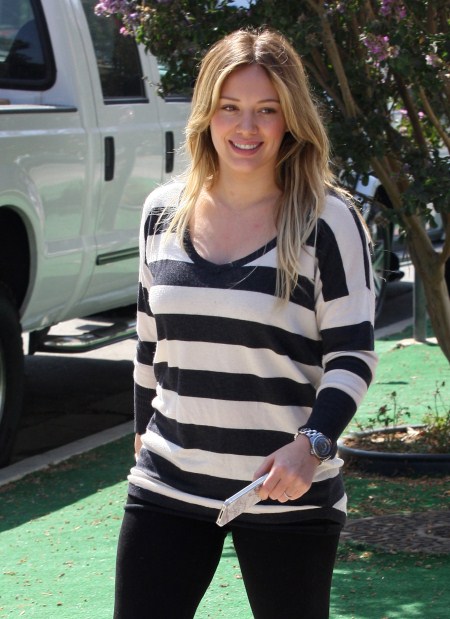 Pregnant Hilary Duff cuts some flowers with her faithful dog at her side then goes to her morning Pilates class in Toluca Lake, California on September 20, 2011.