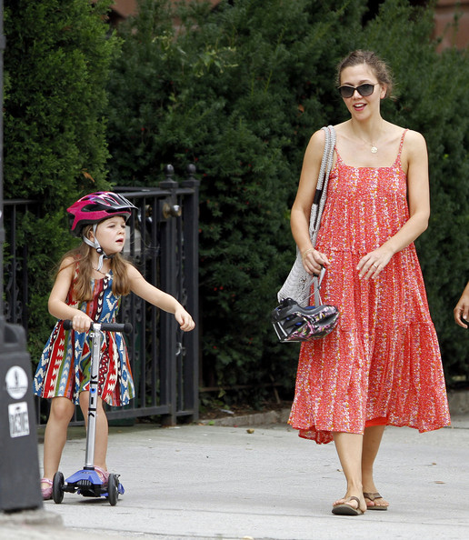 Maggie Gyllenhaal watches as her daughter Ramona rides her scooter around Brooklyn
