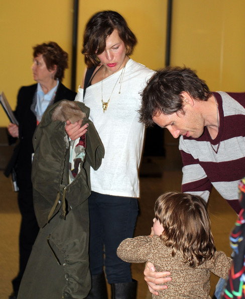 Milla Jovovich, her husband Paul W.S. Anderson and daughter Ever arriving at the airport in Toronto, Canada