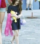 Suri Cruise, age 5, seen wearing a dark shade of lipstick as she and Katie Holmes arrive back at their NYC apartment.