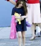 Suri Cruise, age 5, seen wearing a dark shade of lipstick as she and Katie Holmes arrive back at their NYC apartment.