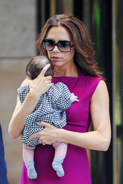 Victoria Beckham holds Harper close as she leaves the Plaza Hotel in New York City after having lunch.