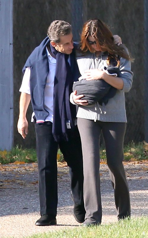 Nicolas and Carla Bruni Sarkozy and their newborn daughter Giulia take a walk in Versailles, France