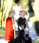 Marcia Cross makes some last minute adjustments to the Halloween costumes of her twin daughters, Eden and Savannah before they go into a party.