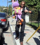 Model Gabriel Aubry picks up his daughter Nahla from school on February 8, 2012 in Los Angeles, CA. Nahla was barely visible behind the giant, purple stuffed animal she was carrying!