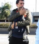 Orlando Bloom arrives at LAX Airport with his son Flynn to catch a flight out of town on March 4, 2012 in Los Angeles, CA.