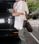 Pregnant actress Uma Thurman arrives at her apartment carrying fresh orange juice