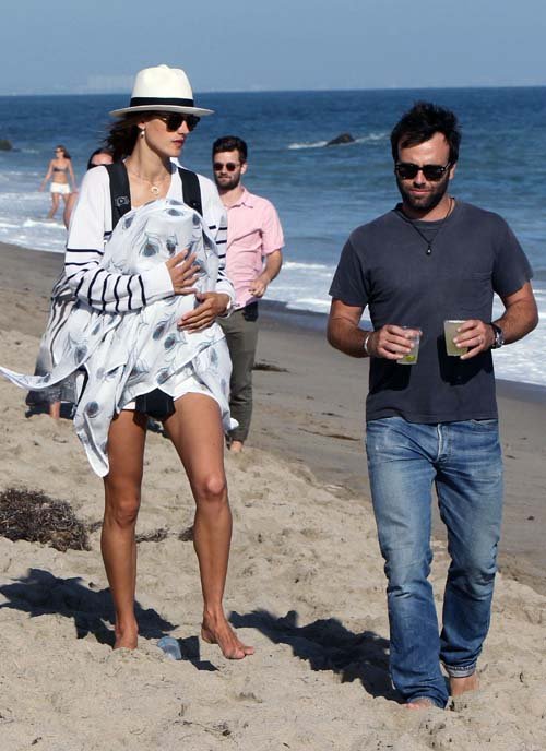 Model Alessandra Ambrosio enjoyed a stroll down the beach in Malibu, California on July 14, 2012 with her newborn son Noah and her long-term fiance Jamie Mazur.